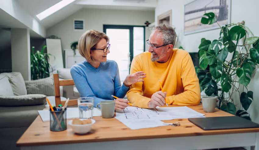 Mature couple reviewing building plans