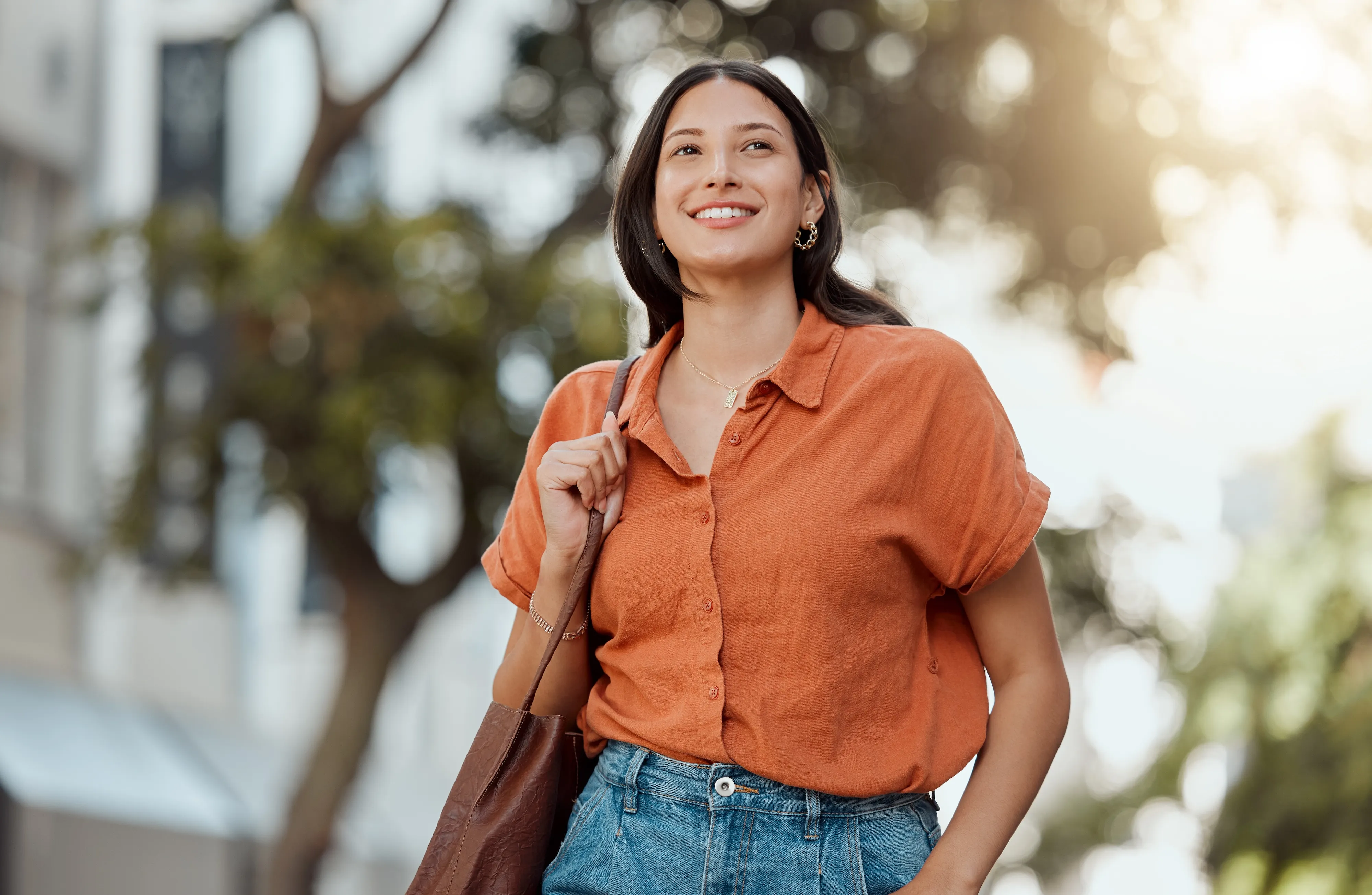 Young woman enjoying a sunny day in Salt Lake City walking near apartments at aQui 355