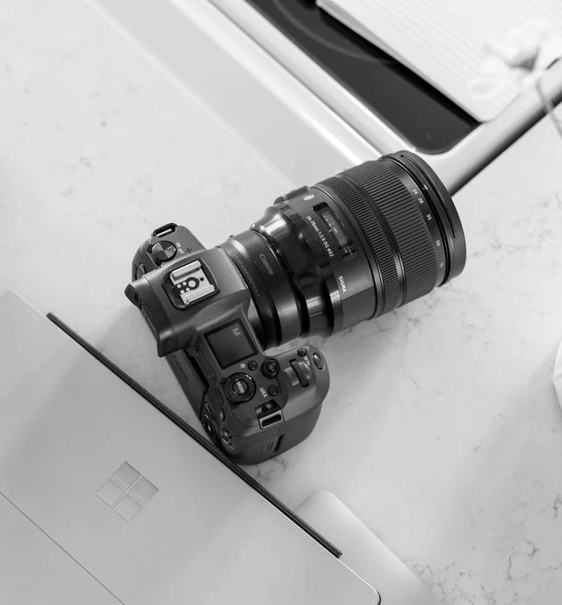 camera on table next to laptop