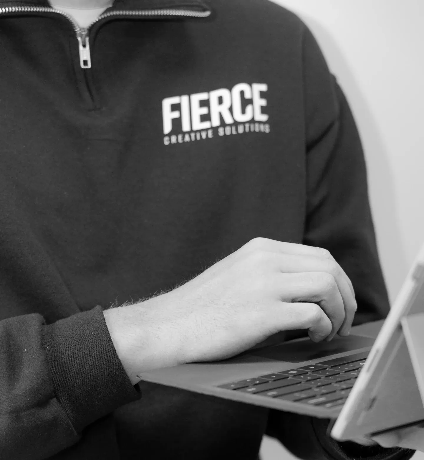person holding laptop while working with one hand