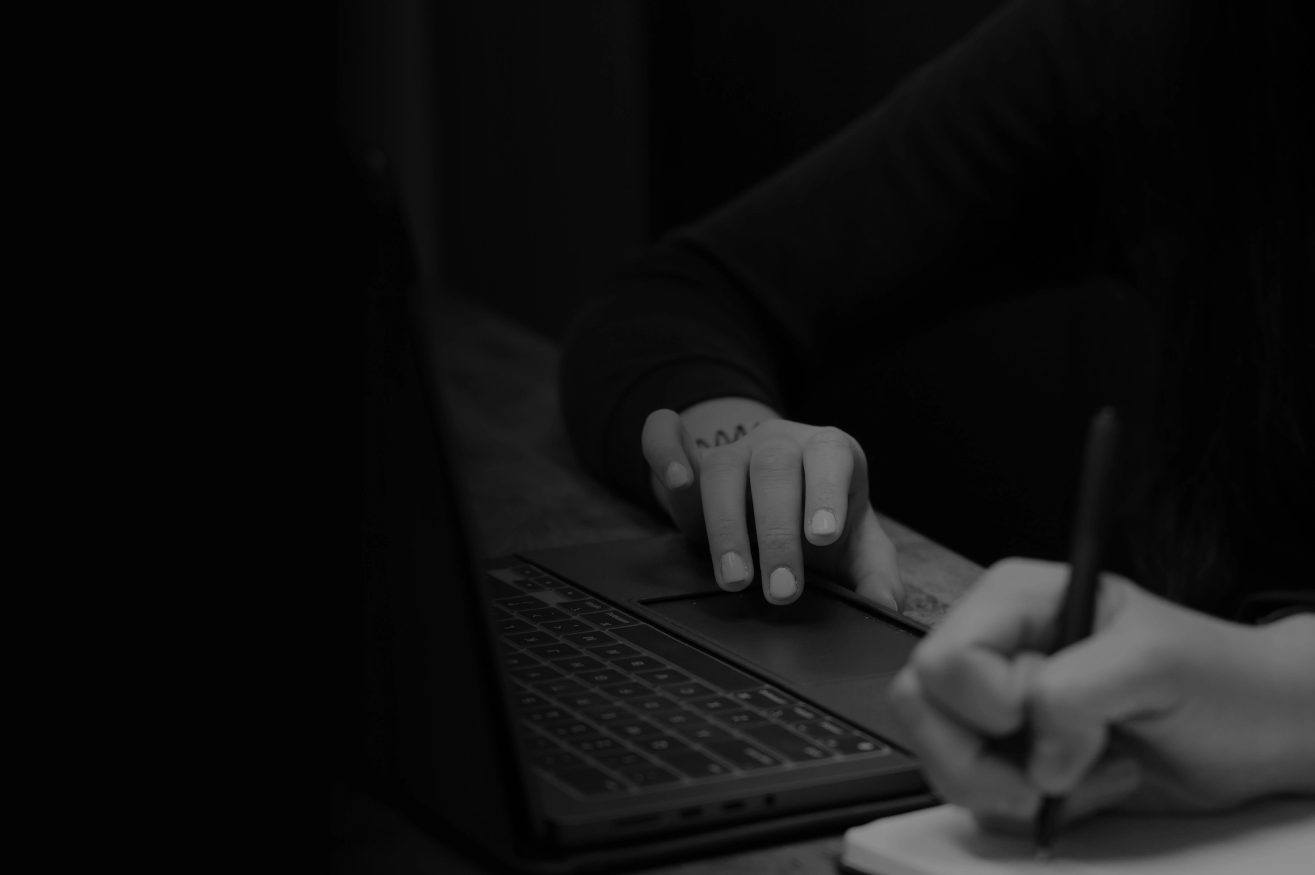 fingers on laptop trackpad