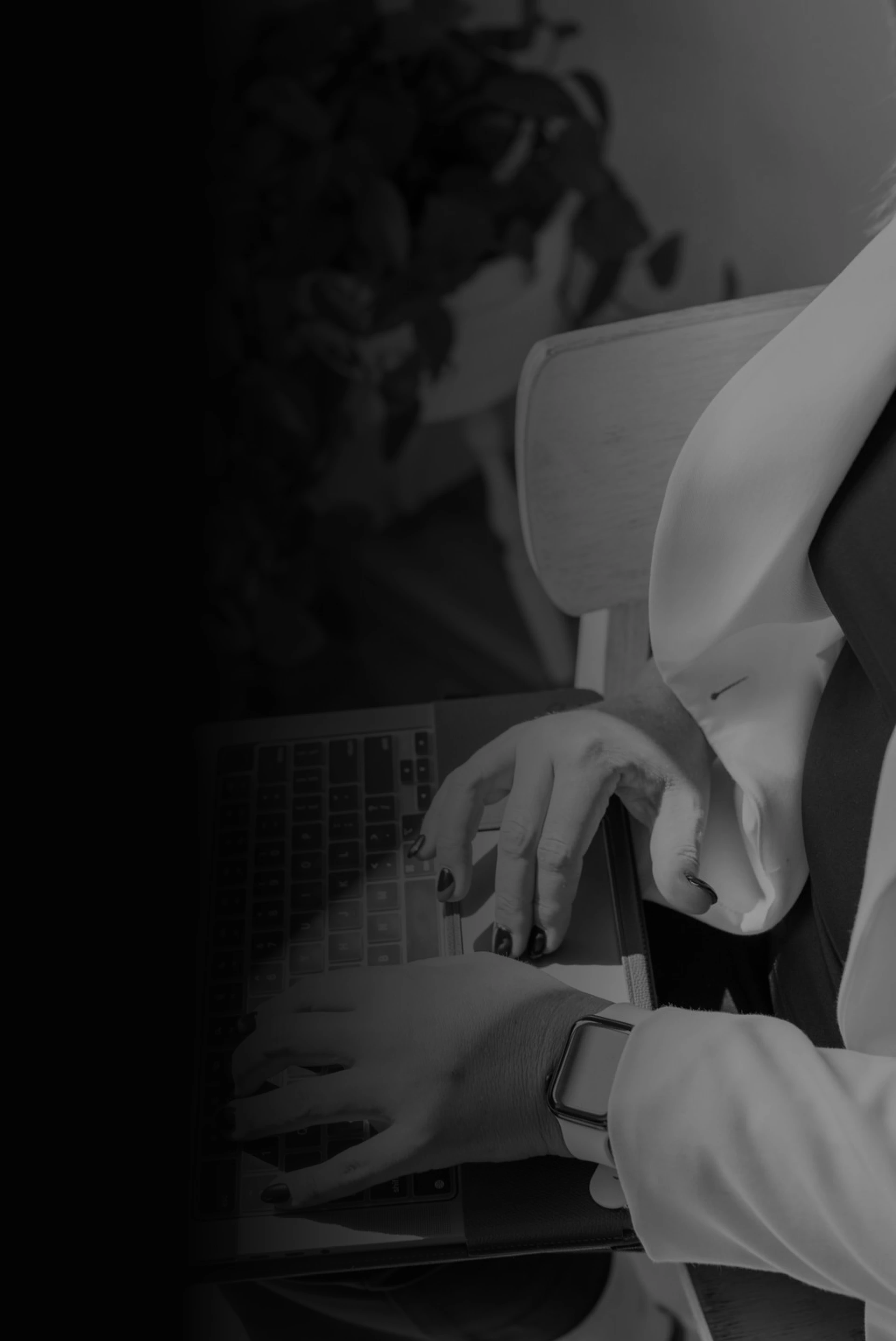 hands on laptop keyboard grayscale with gradient