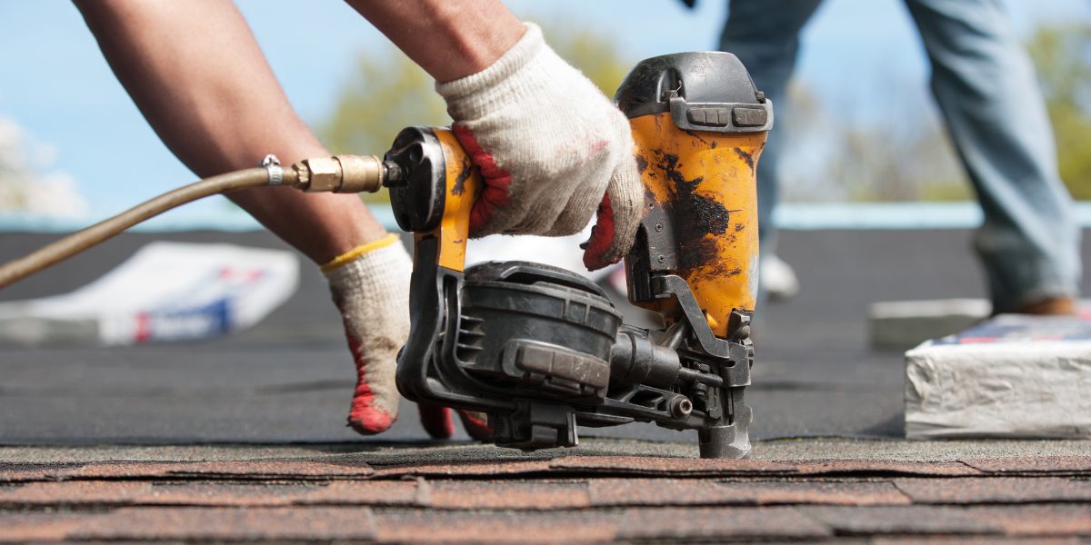 roofing contractor working on a roof replacement in Akron, Ohio