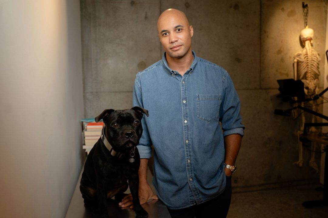 Dr Izzy Lewis, founder of BRAIN TO BODY®, with his dog Hoff in the Chippendale studio