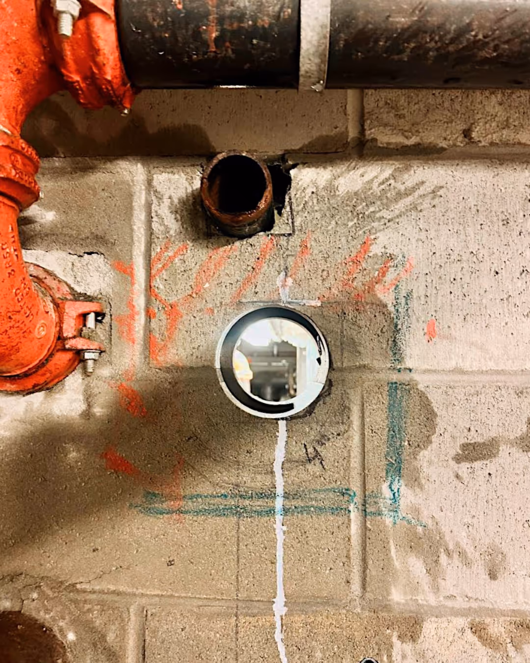 Metal guide installed for precision wall saw cutting.