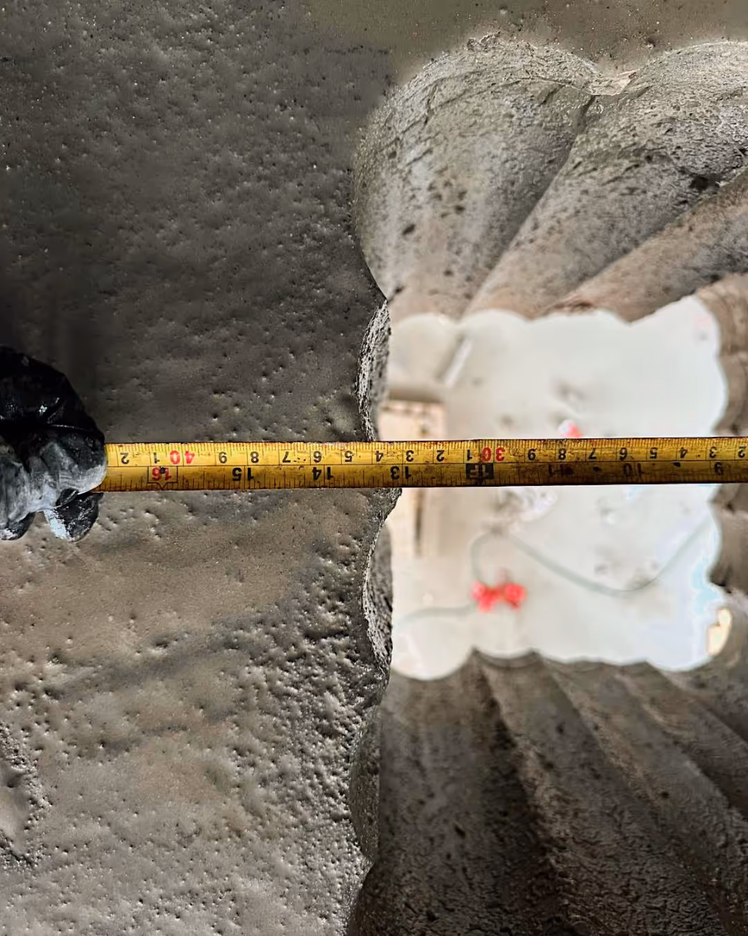 Diamond blade vertically cutting a reinforced concrete structure.