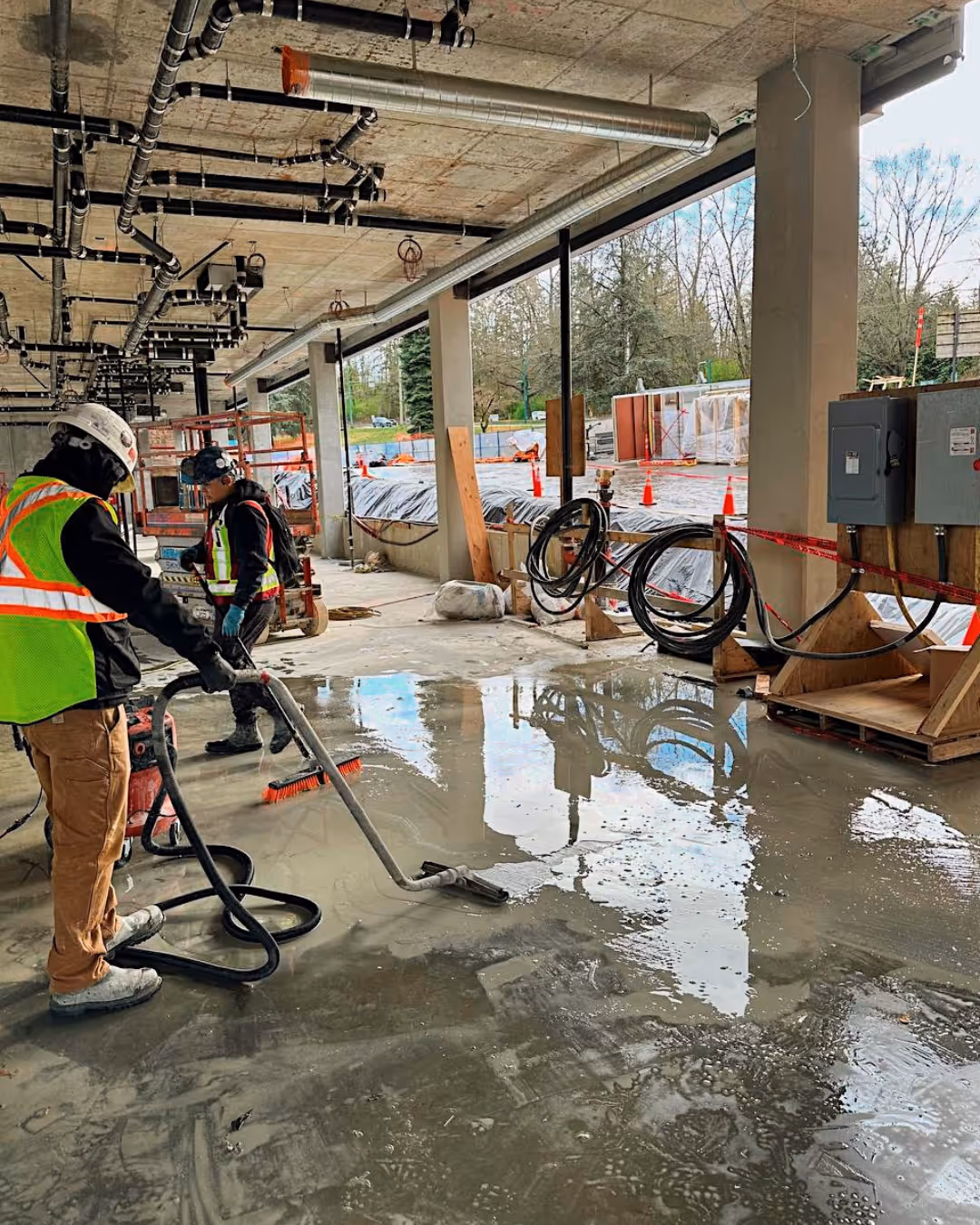 Worker performing precision concrete wall cutting with a red circular saw.