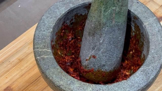 pâte de curry rouge en préparation dans un mortier