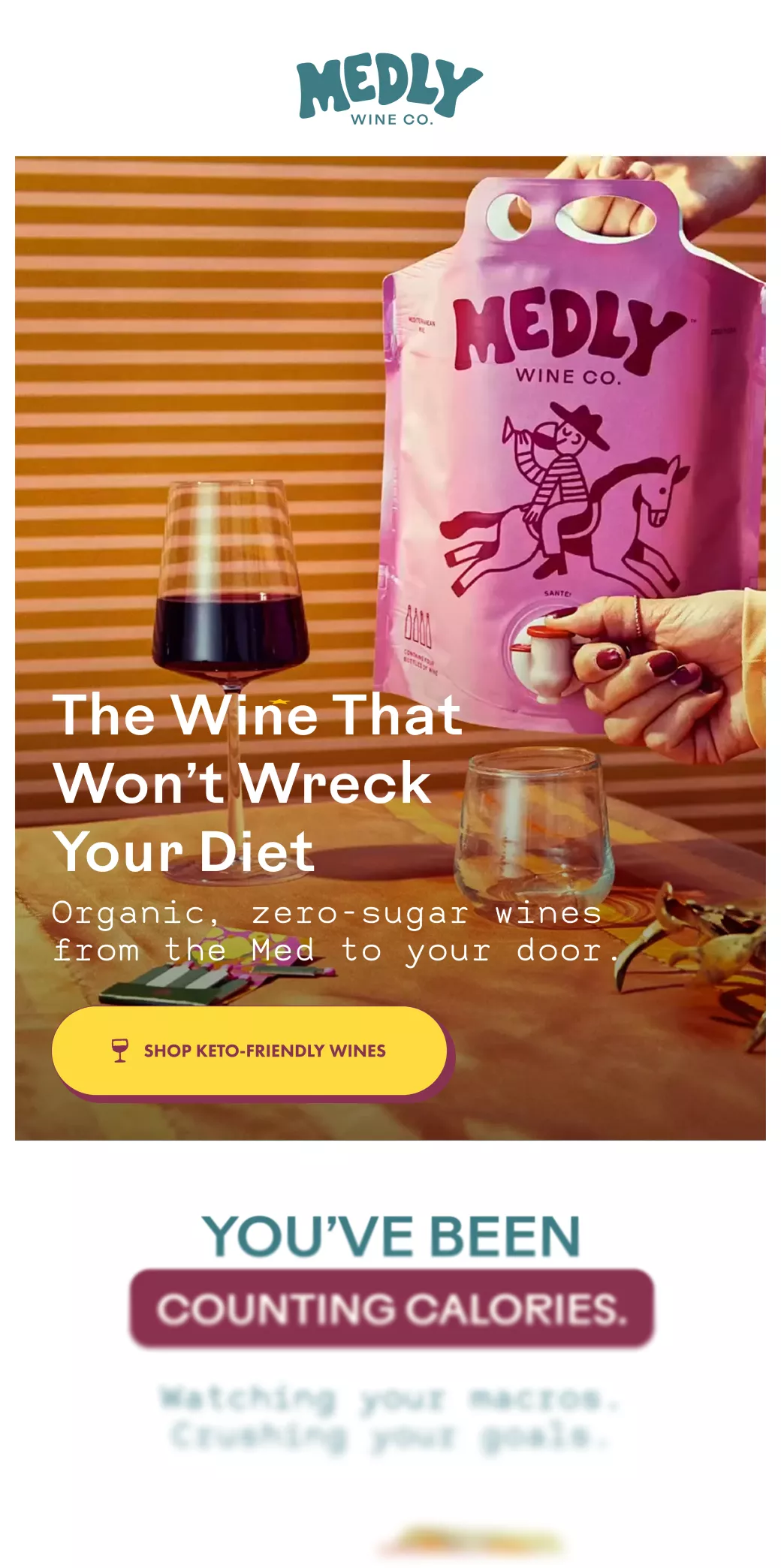 Person holding a pink pouch of Medly Wine Co. organic, zero-sugar wine being poured into a glass next to a filled wine glass on a table with striped background.