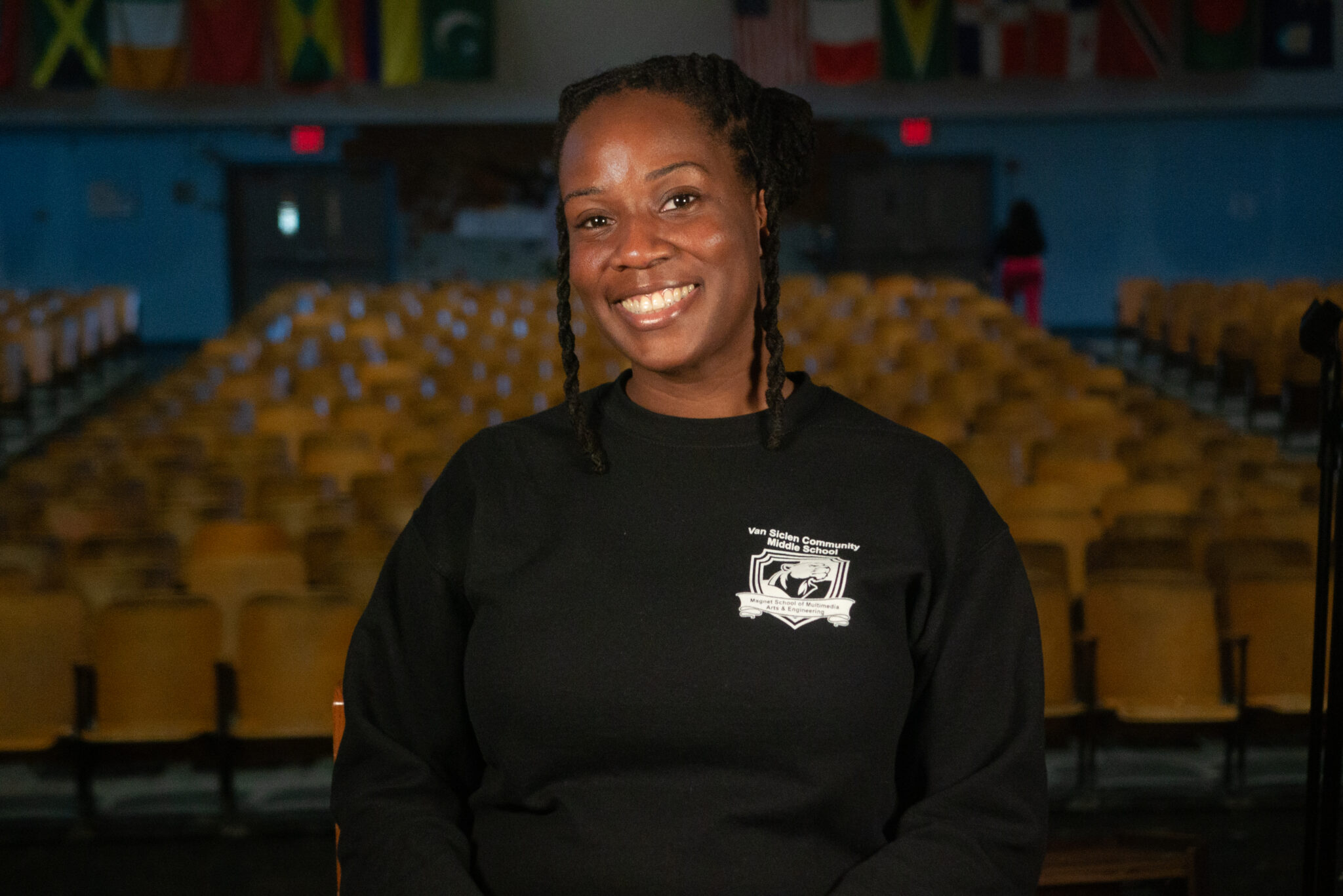 Smiling staff member wearing a Van Siclen Community Middle School sweatshirt