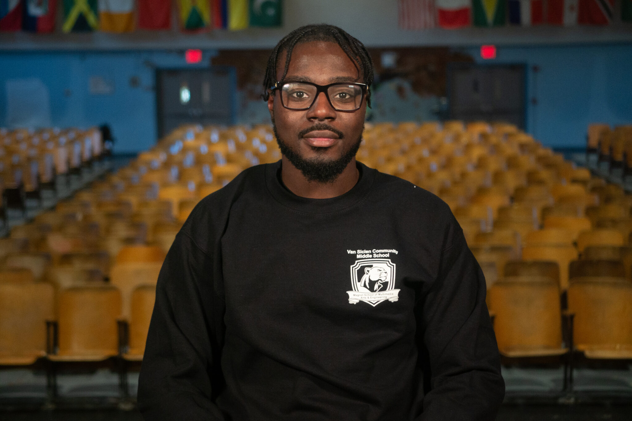 Mohamed Alaka seated in Van Siclen Community Middle School auditorium