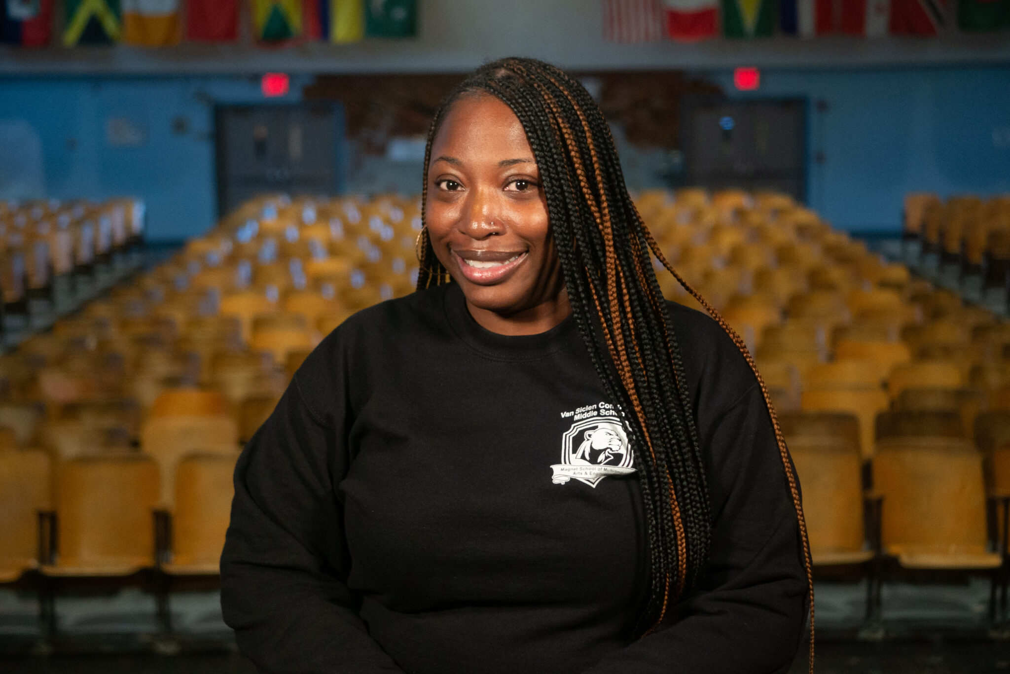 Smiling Van Siclen Community Middle School staff member in auditorium