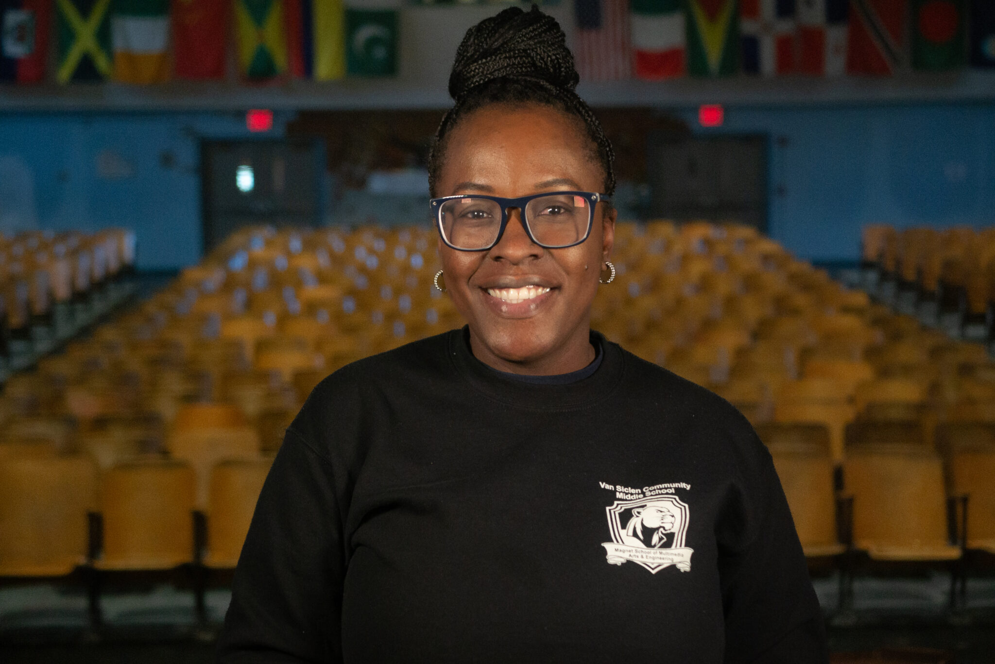 Smiling staff member in Van Siclen Community Middle School sweatshirt