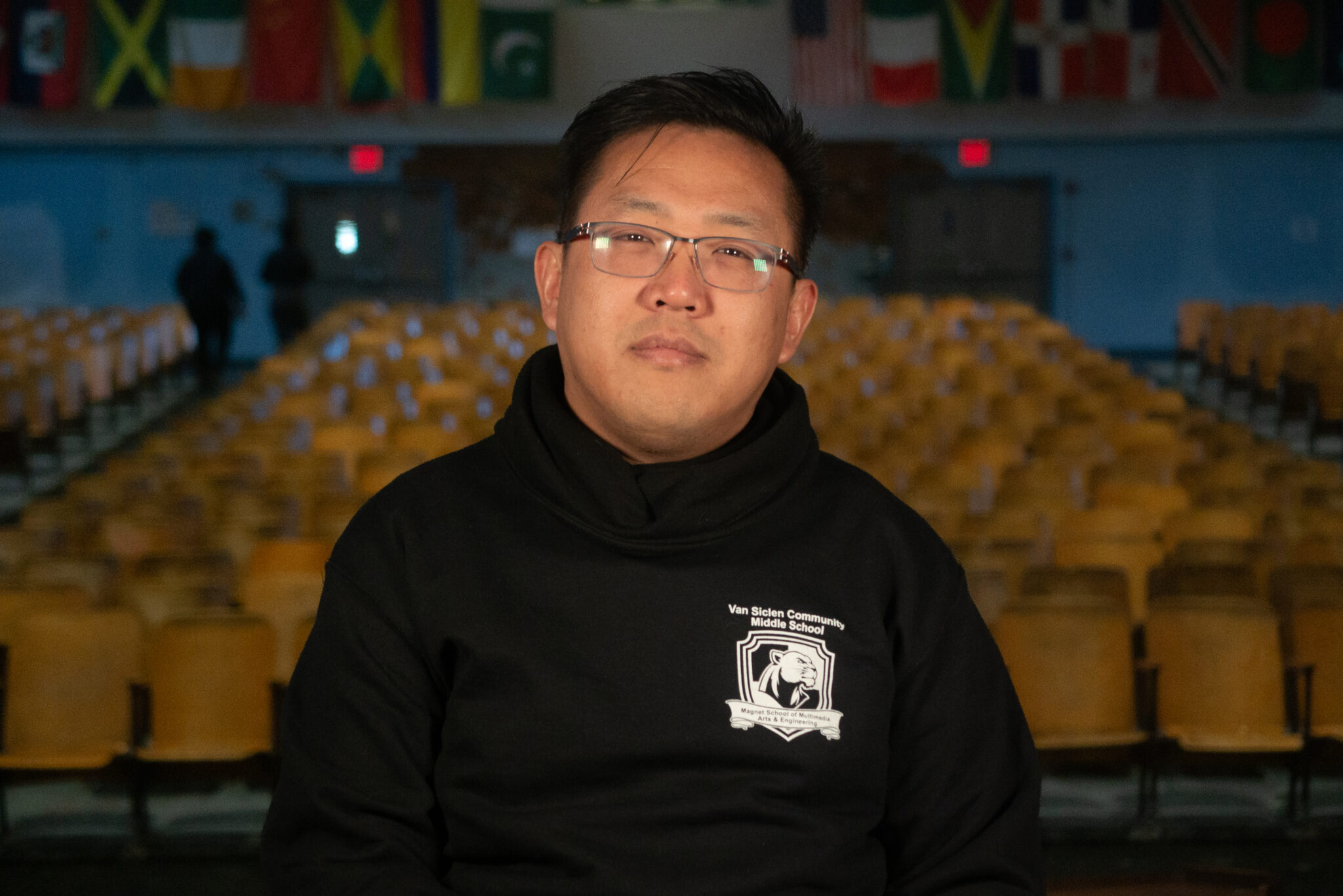 Staff member David Wong in Van Siclen Community Middle School auditorium