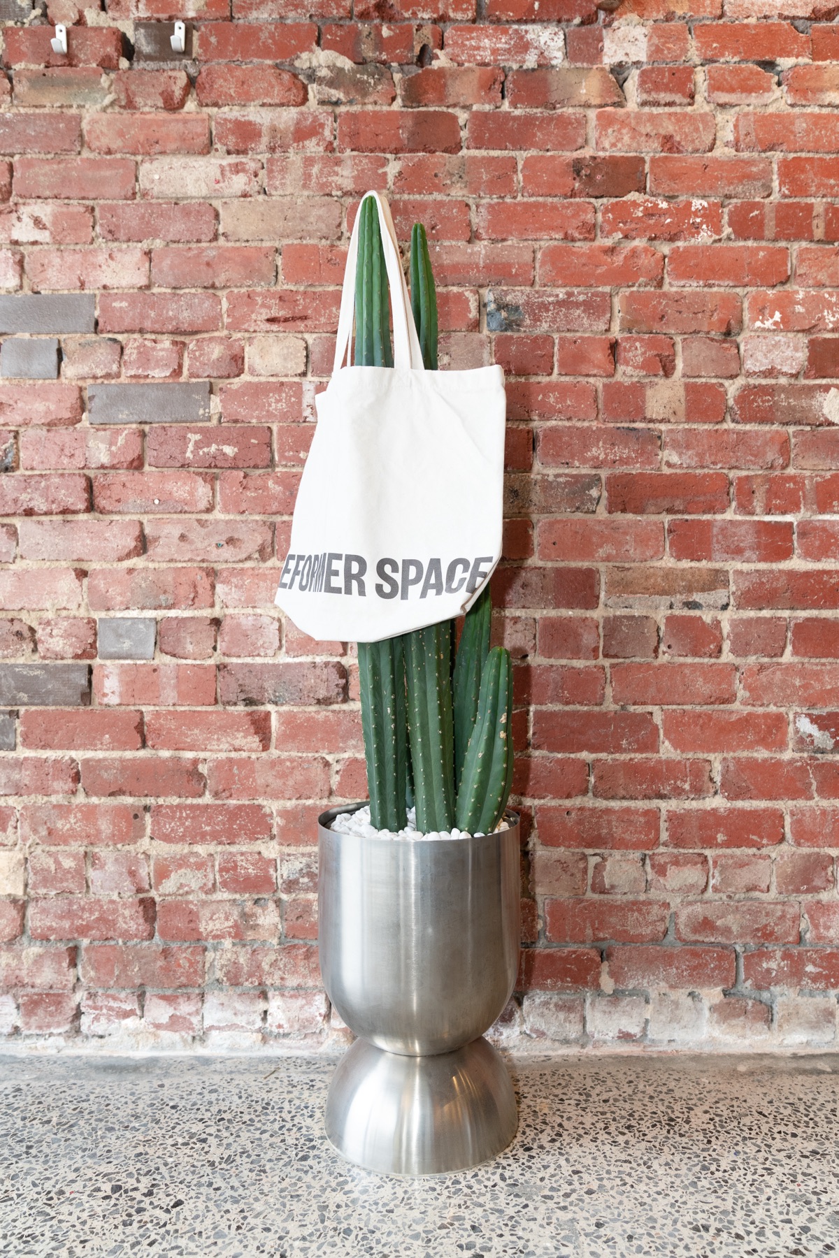 A Reformer Space tote against the brick wall at Richmond