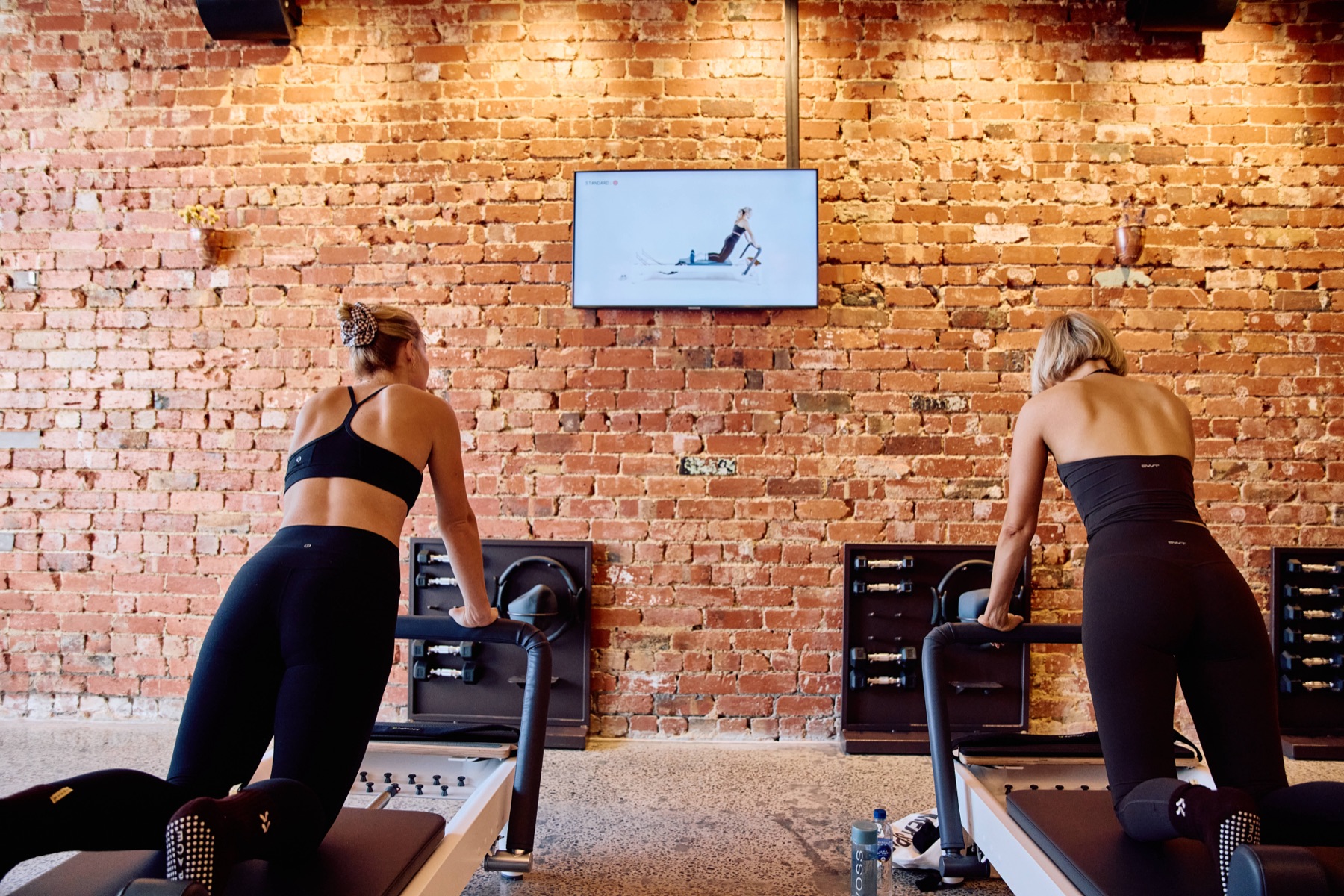 Members following the on-screen class at Reformer Space Richmond