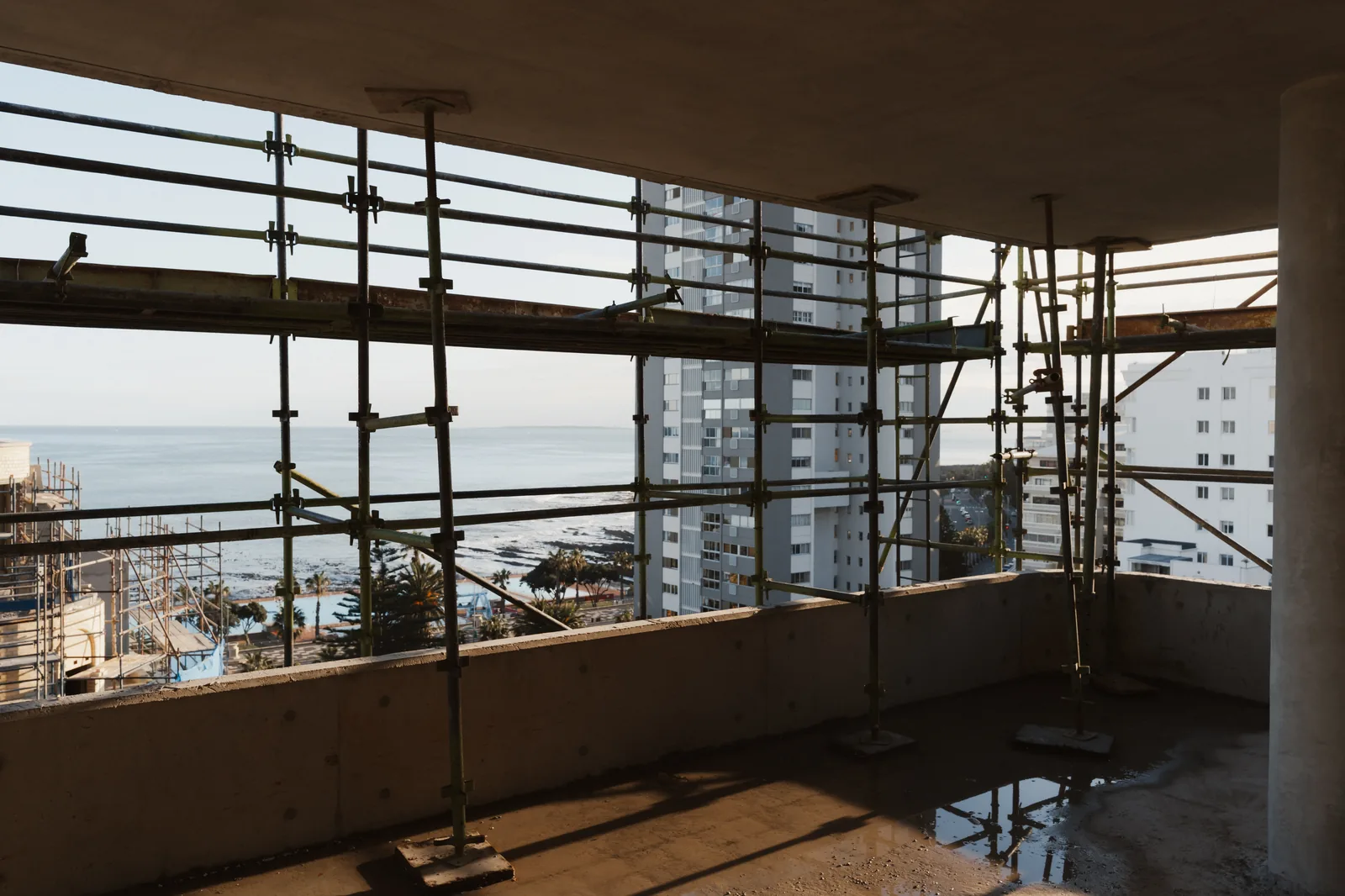 View of the Atlantic Ocean and Sea Point from inside Mont Reve through scaffolding