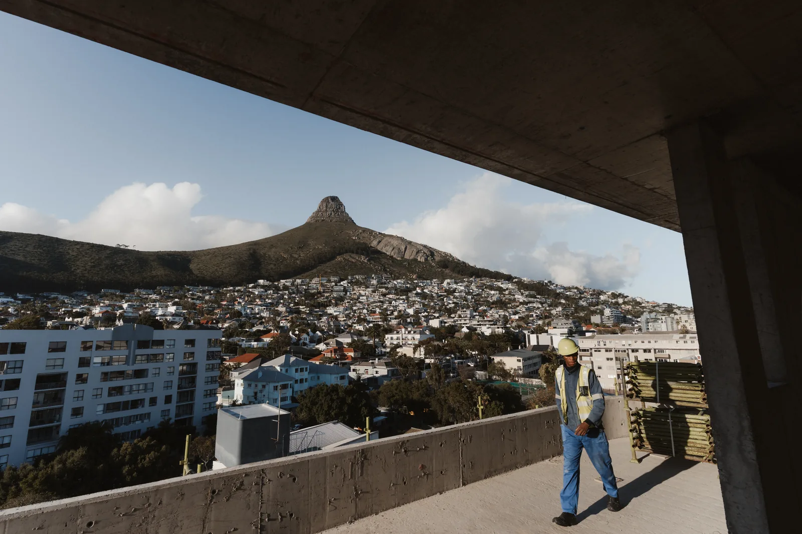 Construction worker on the Mont Reve site with Lion's Head in the background