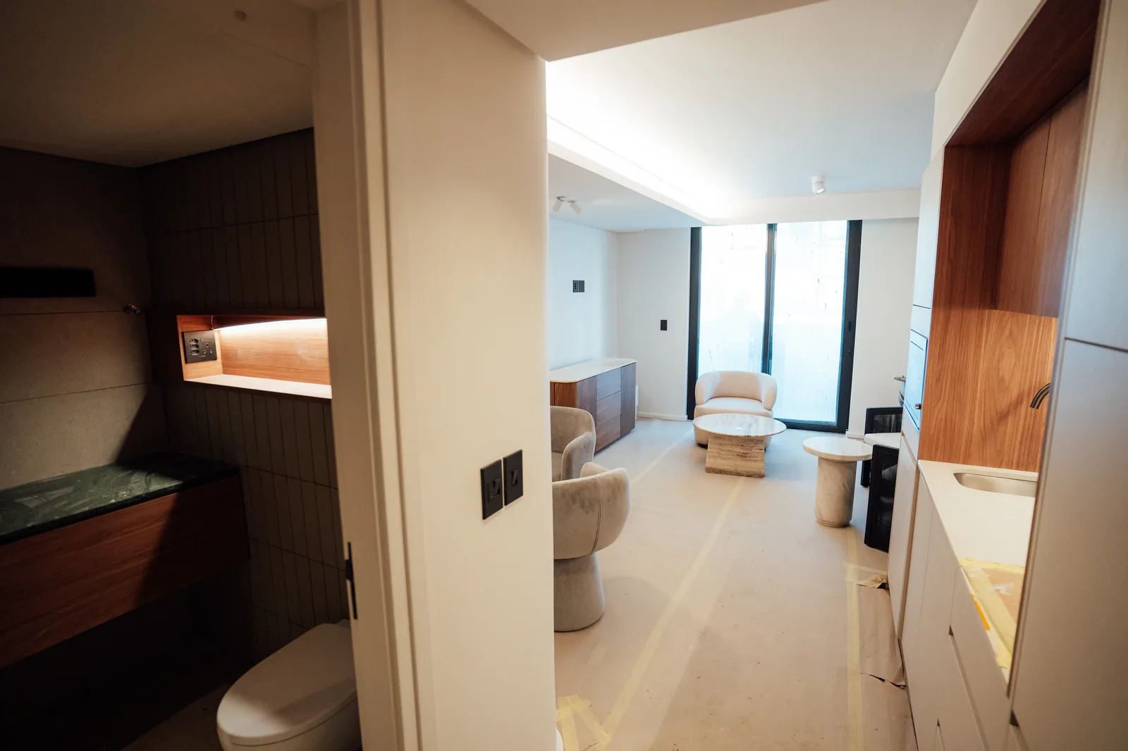 A completed Mont Reve apartment interior with joinery, stone finishes and furniture in place