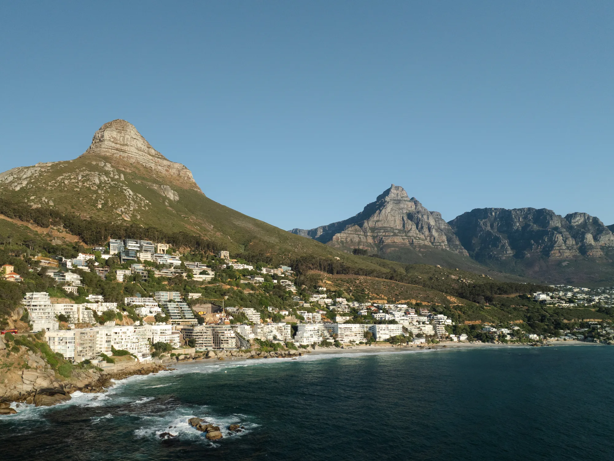 Aerial view of Clifton and Camps Bay beneath Lion’s Head and the Twelve Apostles, Cape Town’s Atlantic Seaboard.