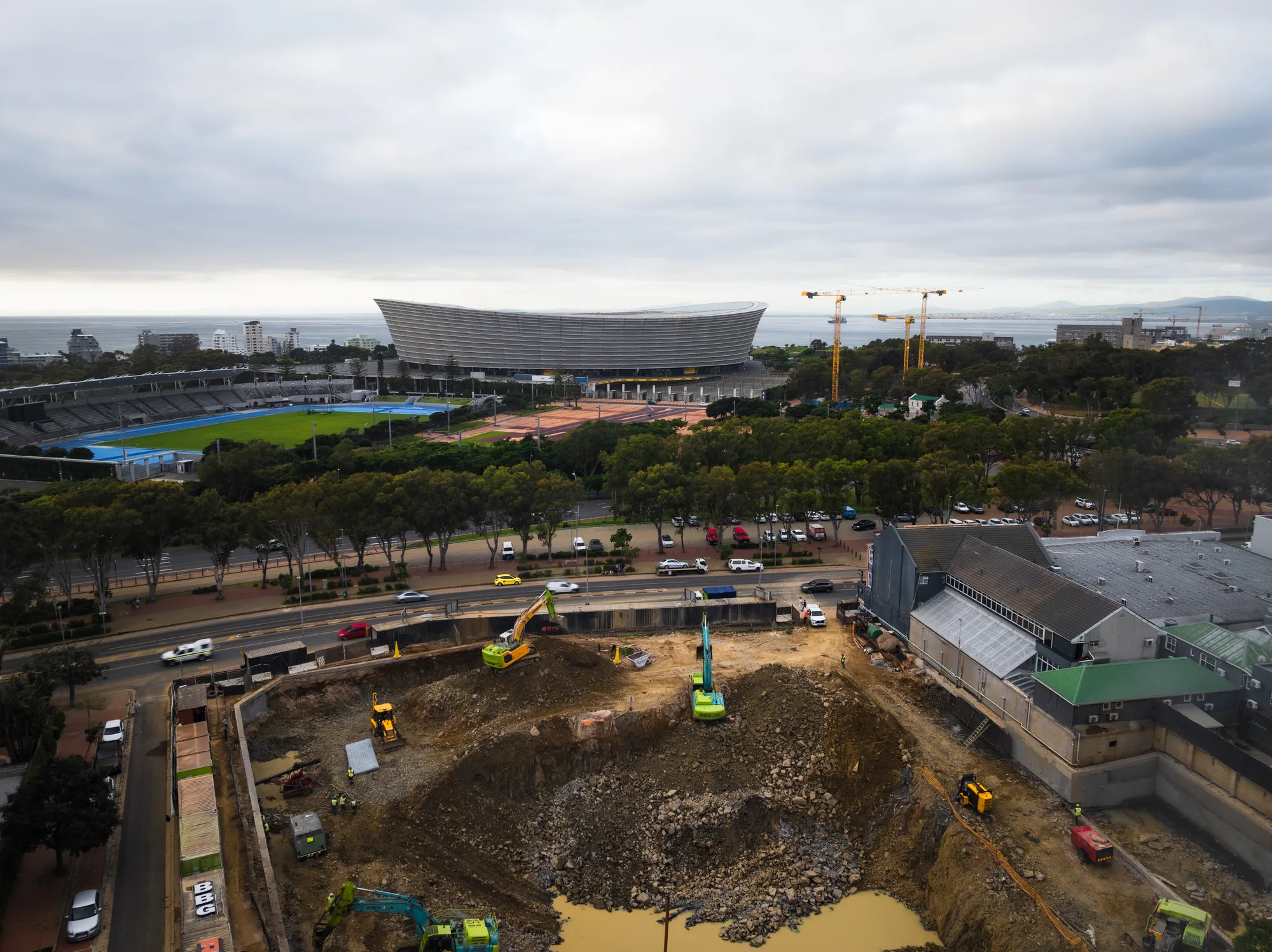 Aerial view of a Berman Brothers Group development site in Green Point, with Cape Town Stadium and the Atlantic beyond.