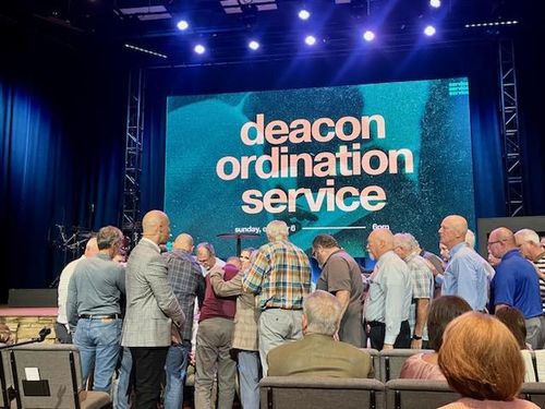 Deacons praying over candidates.
