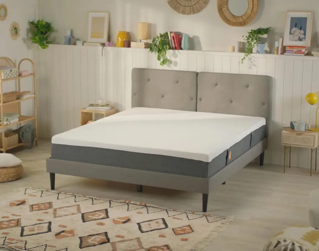 A comfortable bed and a mattress in a comfortable room.