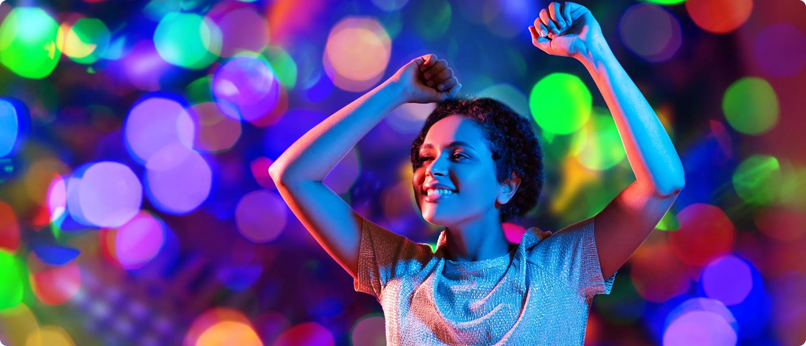 a girl dancing with multiple colors lights around