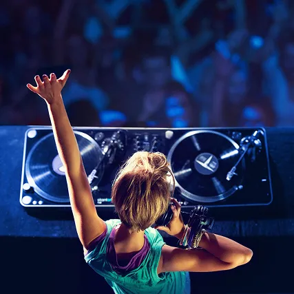 a closeup of a lady dj, blonde