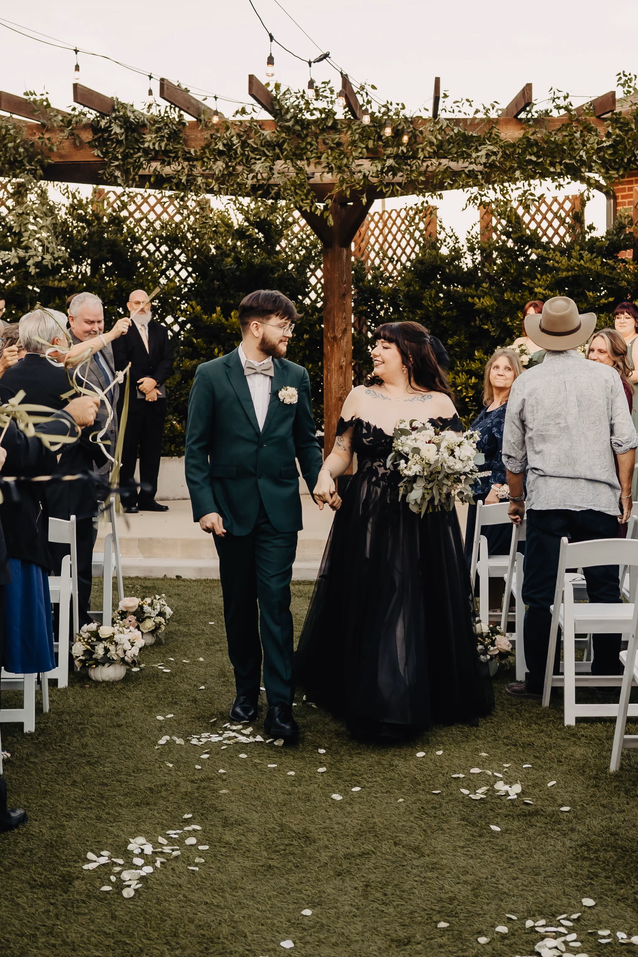 A new bride and groom walking down the isle after a wedding ceremony. 