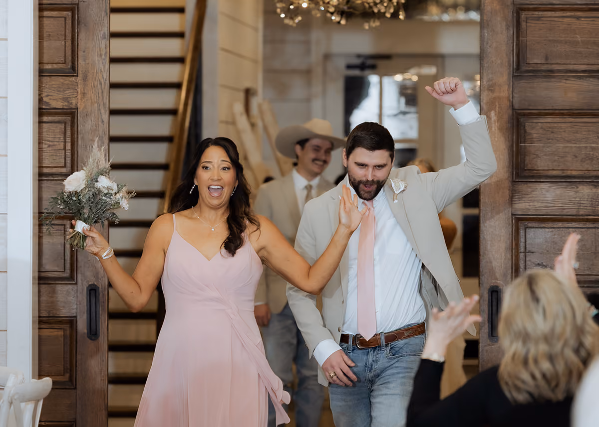 The wedding party making their grand entrance into the wedding reception.