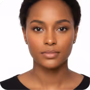 Portrait of a young Black woman with short curly hair wearing a black top against a white background.
