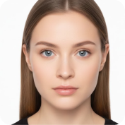 Close-up portrait of a young woman with straight brown hair and blue eyes, looking directly at the camera against a white background.
