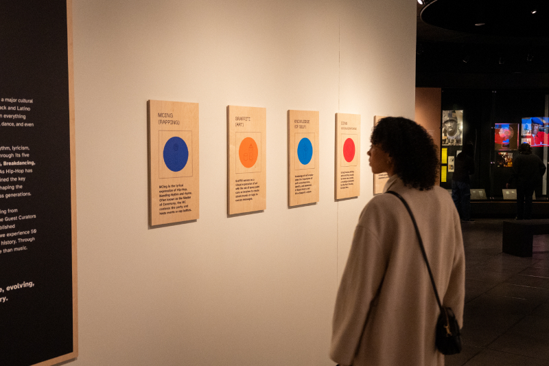 Museum visitor looking at the Beats + Rhymes exhibition at MOPOP