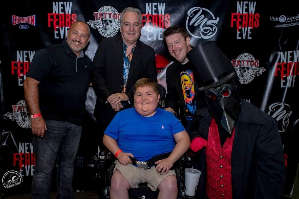 Noah and his father (on the left) with horror filmmakers from Owensboro at their movie premiere, Eric Huskisson (in the middle), and P.J. Starks (on the right)