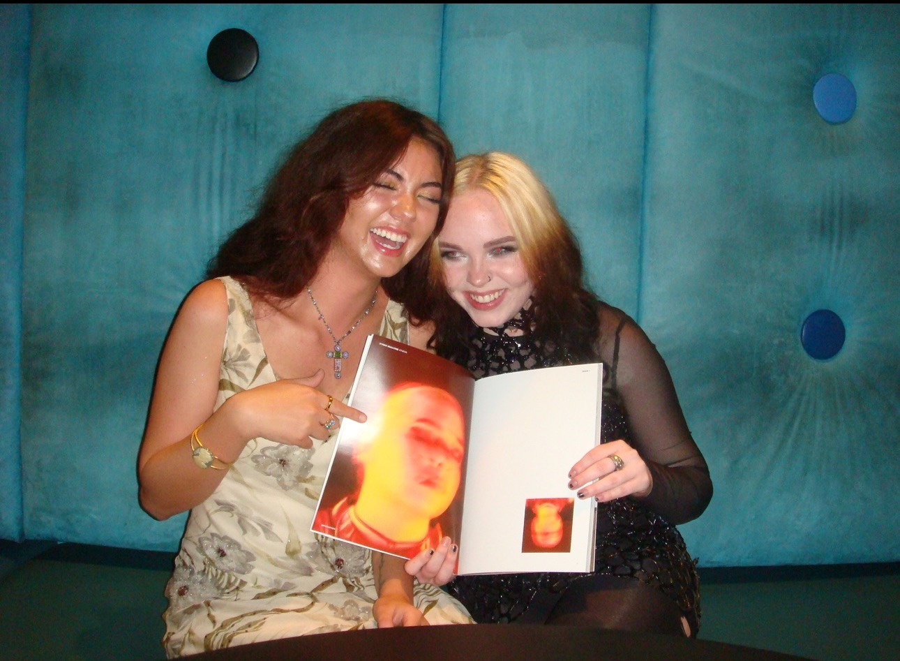 Posing with her roommate holding a copy of Strike Magazine