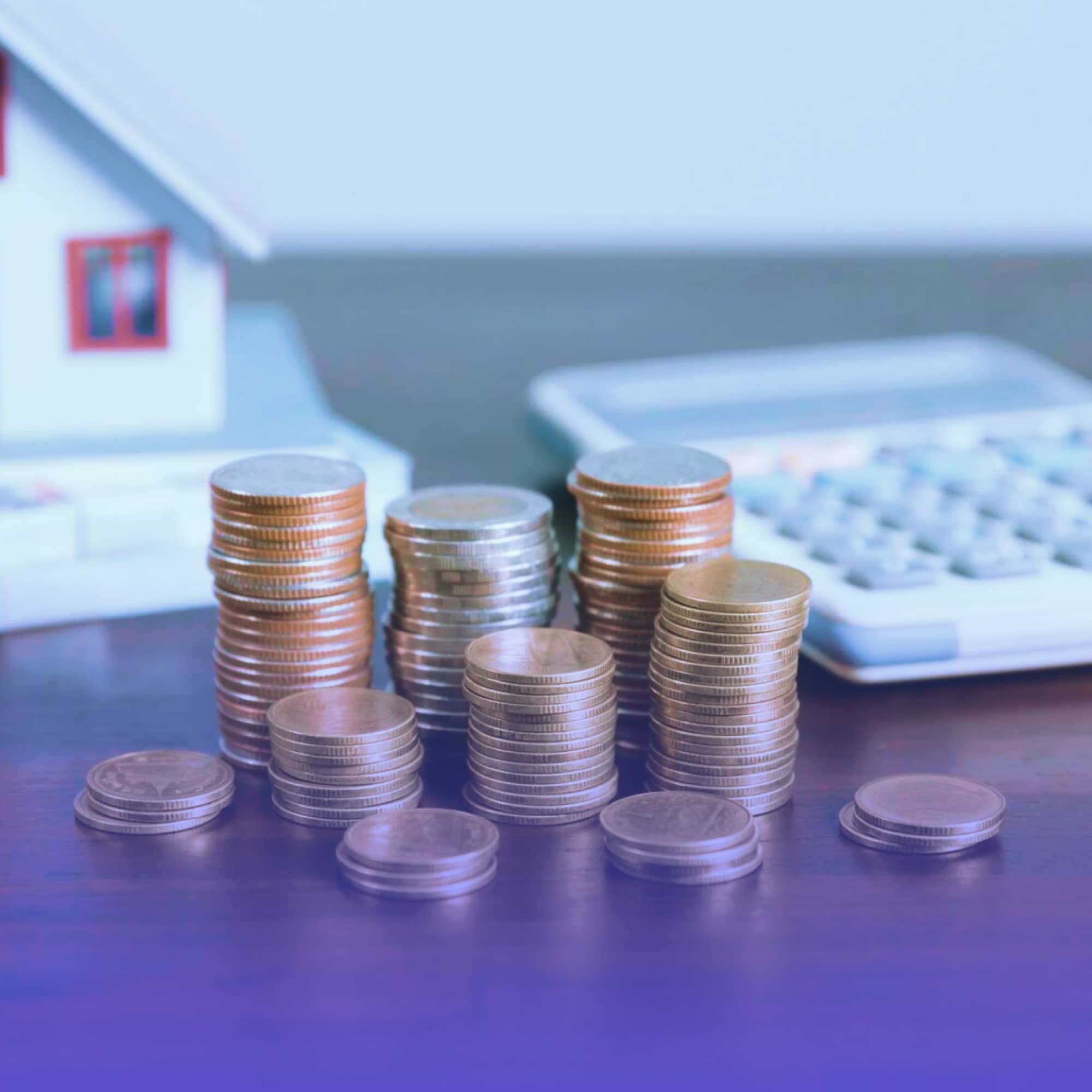 Cofrinho e miniatura de casa representando qual investimento rende mais