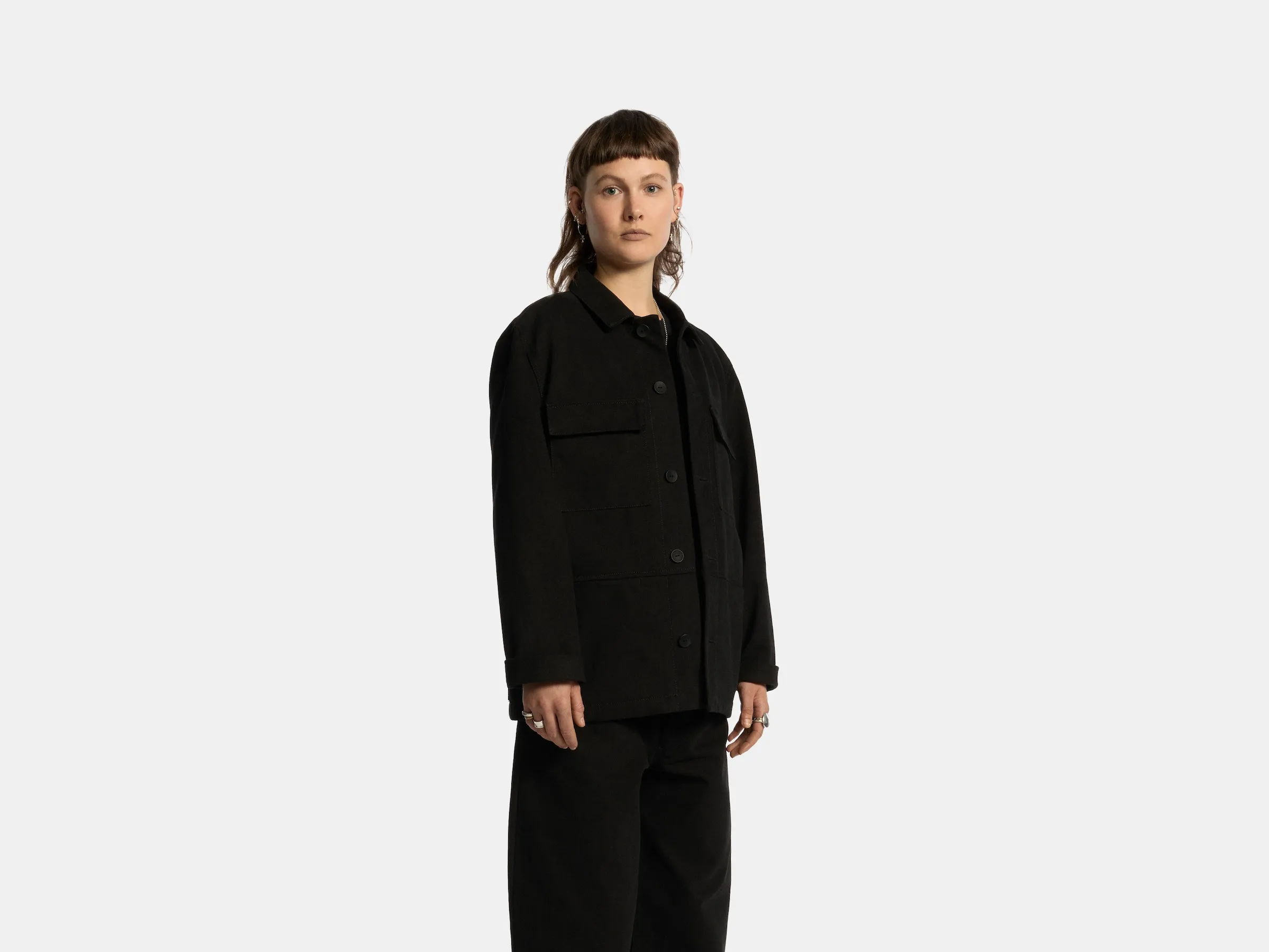 Model wearing the black Odd Uniform jacket and trousers