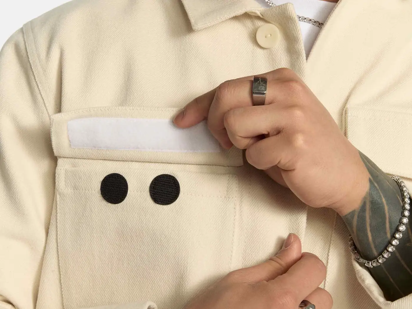 Close-up of the off-white Odd Uniform jacket pocket with the eyes patch