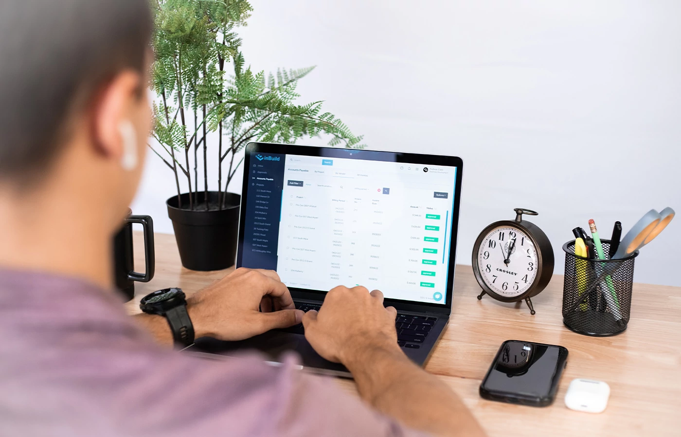 User in the inBuild dashboard at a nicely decorated desk