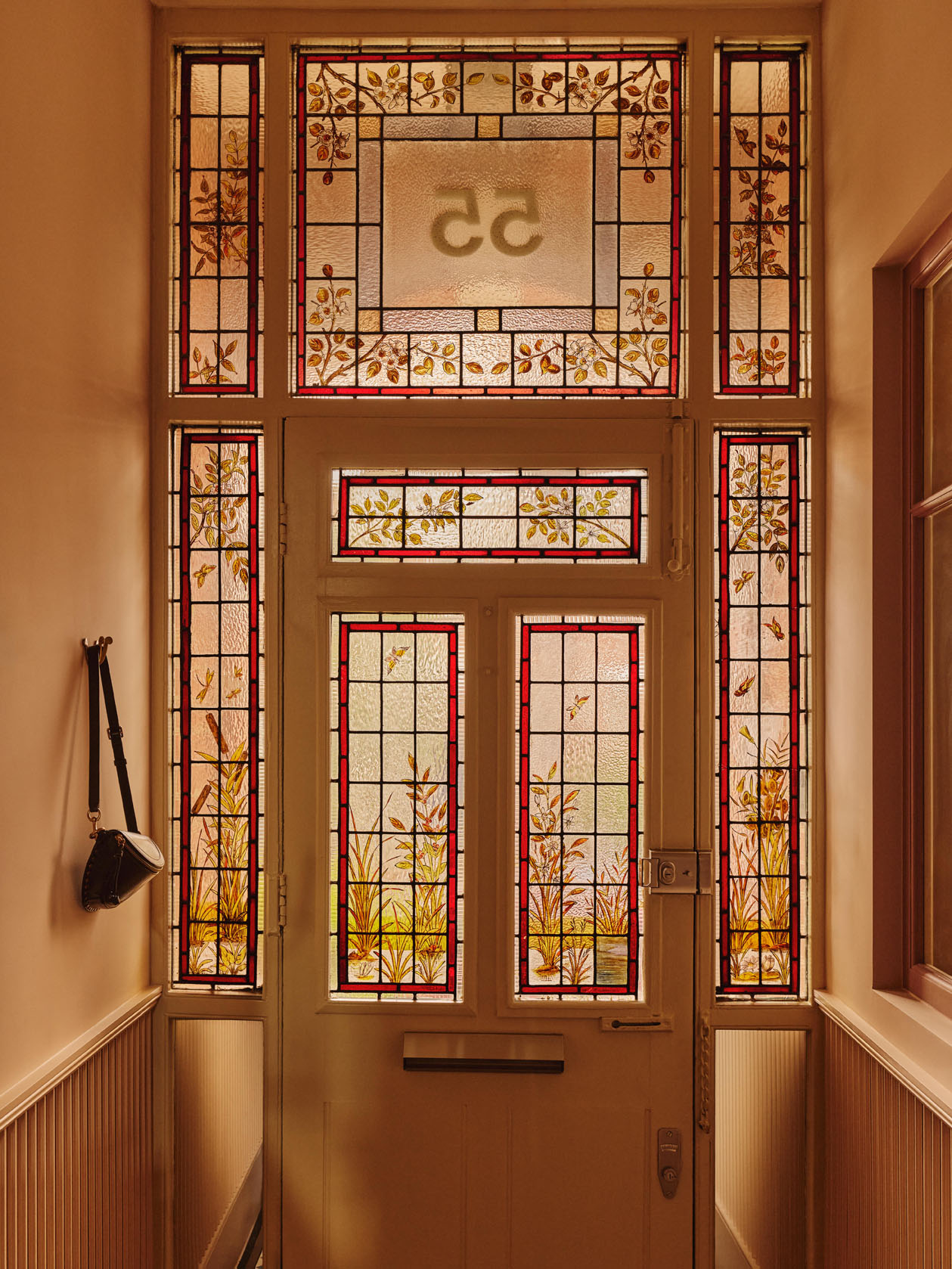 Dining room with cream curtains and steel doors