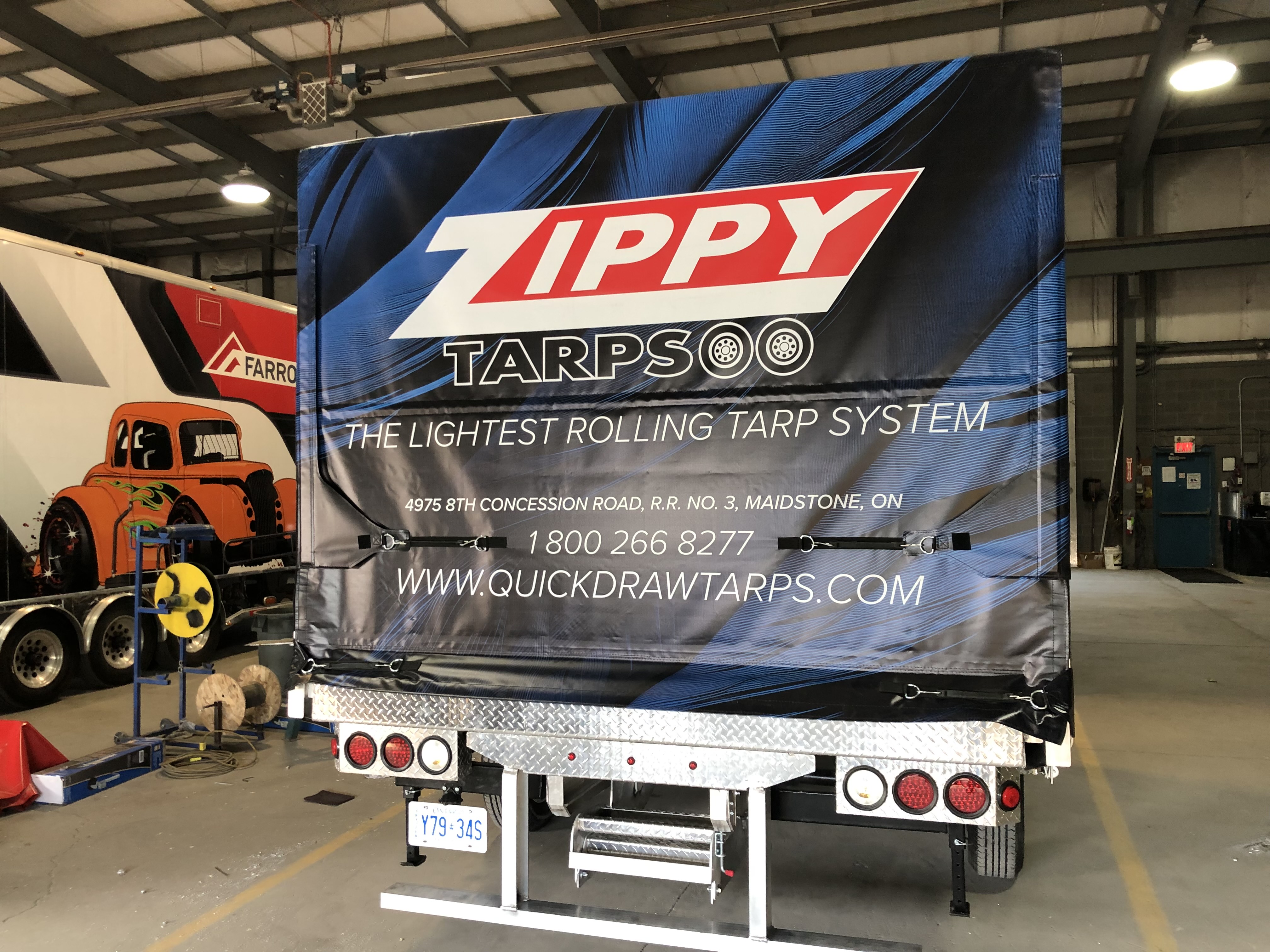 Backside of branded Zippy Tarp on transport truck.