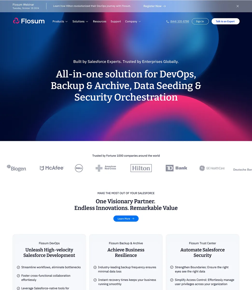 Flosum homepage highlighting an all-in-one DevOps, Backup & Archive, Data Seeding & Security Orchestration solution trusted by major companies including Biogen, McAfee, Dell, American Red Cross, Hilton, TD Bank, GE HealthCare.