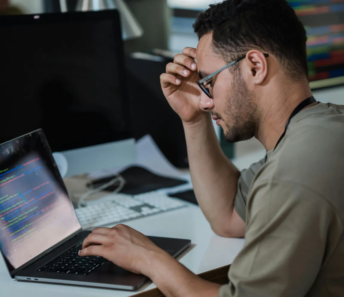 Web developer focusing on code displayed on a laptop screen, representing web app development, digital product growth, and technology solutions for business scalability.