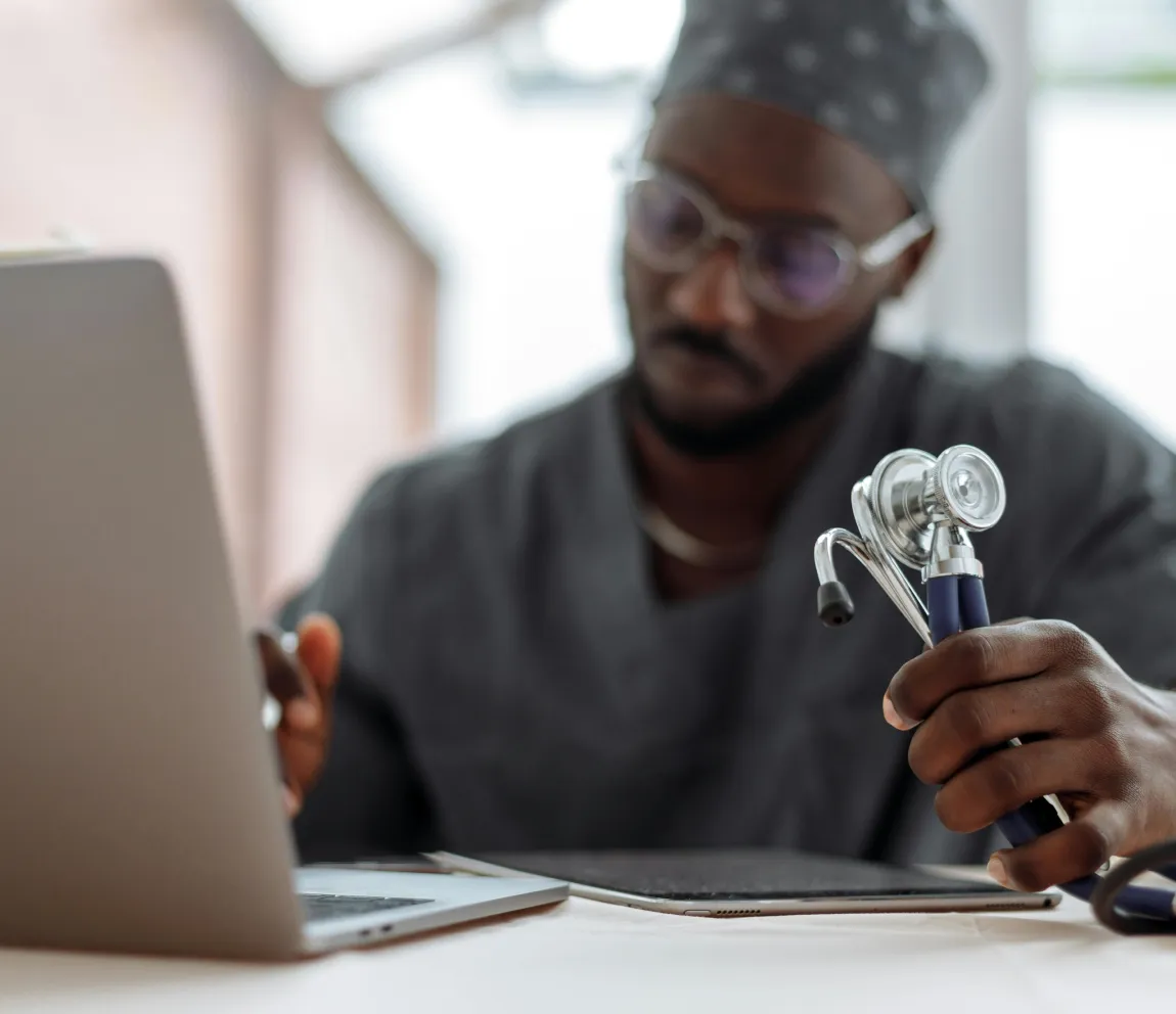 Healthcare professional reviewing medical processes on a laptop to improve digital workflows and optimize healthcare operations with Momentum’s technology solutions.