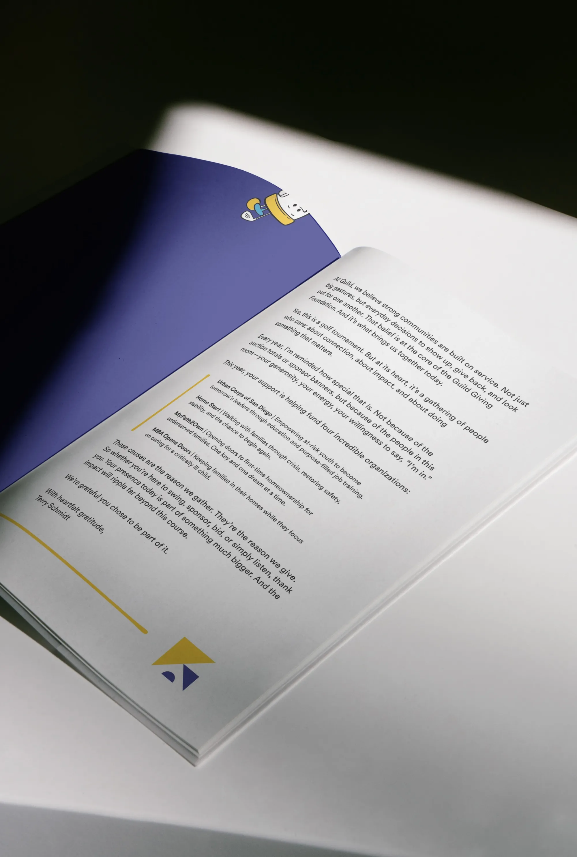 Open Guild brand book showing a message about community service and support for nonprofit organizations with text on white pages.