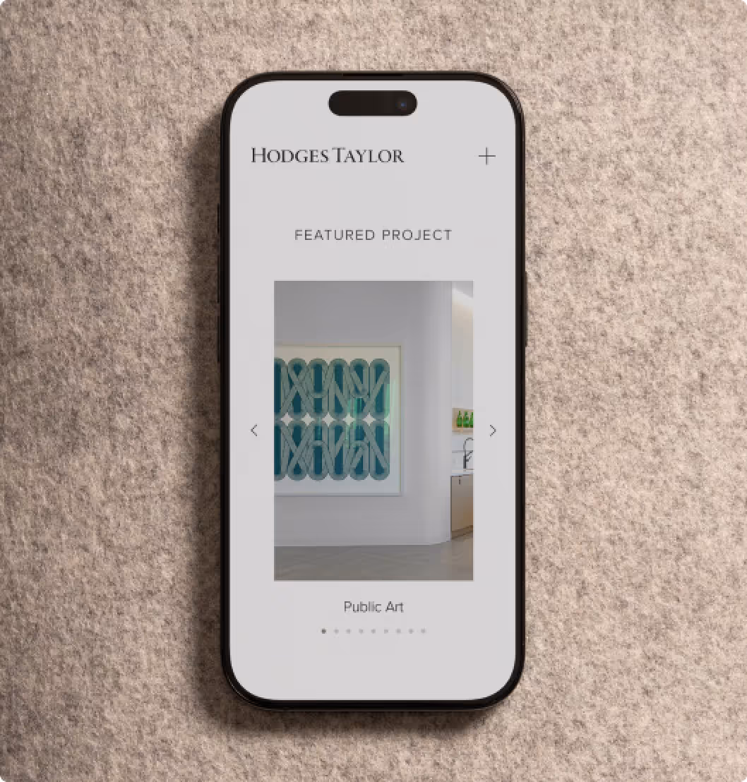 Smartphone displaying Hodges Taylor website featuring a public art project with abstract blue and white artwork.