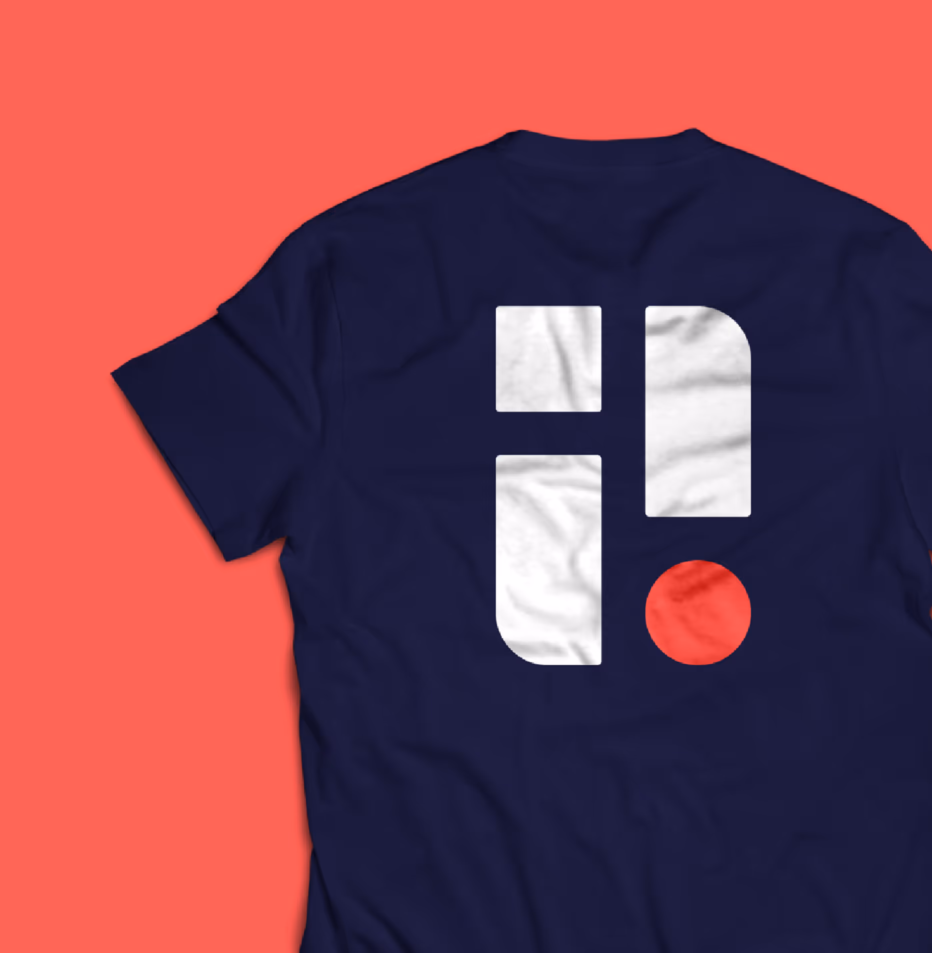 Navy blue t-shirt with a geometric design consisting of two white rounded rectangles, one white square, and one red circle on the back.