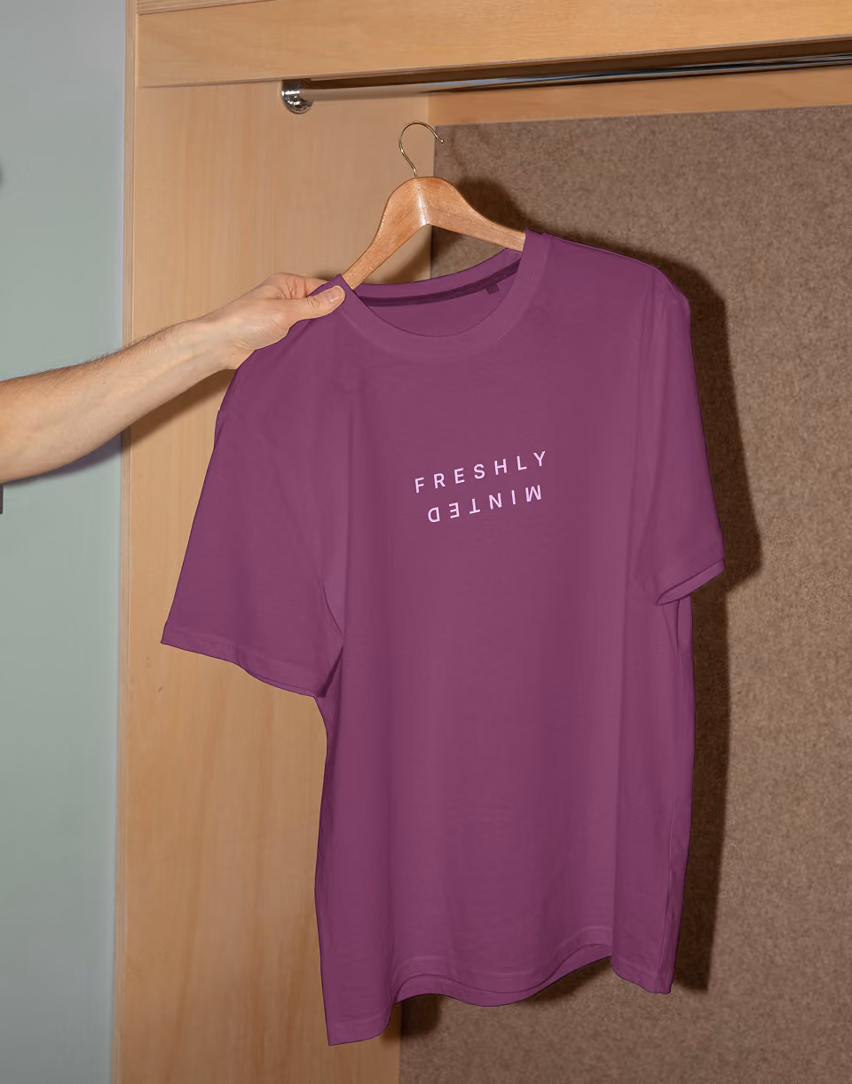 A dark purple South Mint branded shirt on a hanger