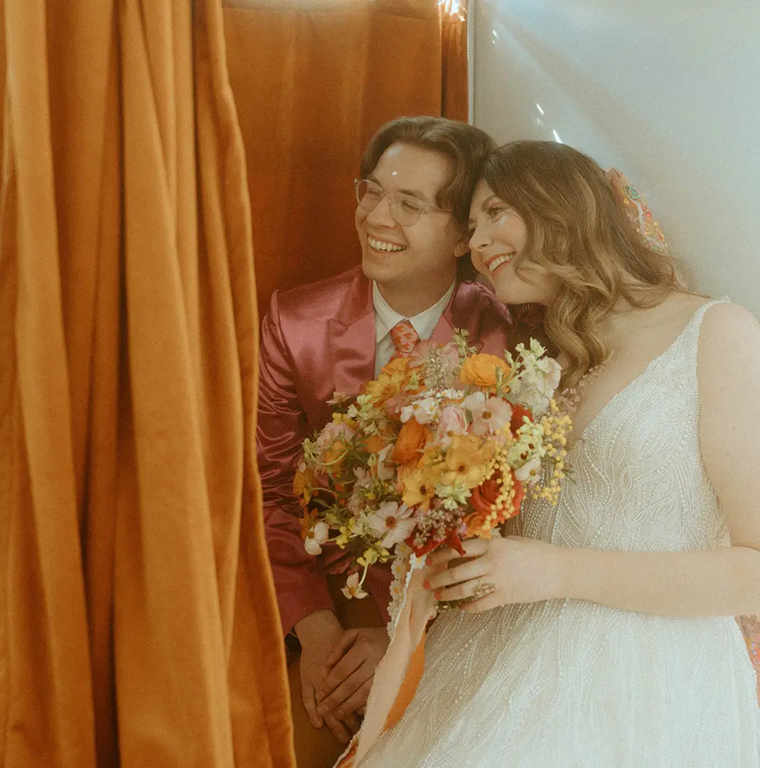 A couple wonders how much to rent a photo booth.